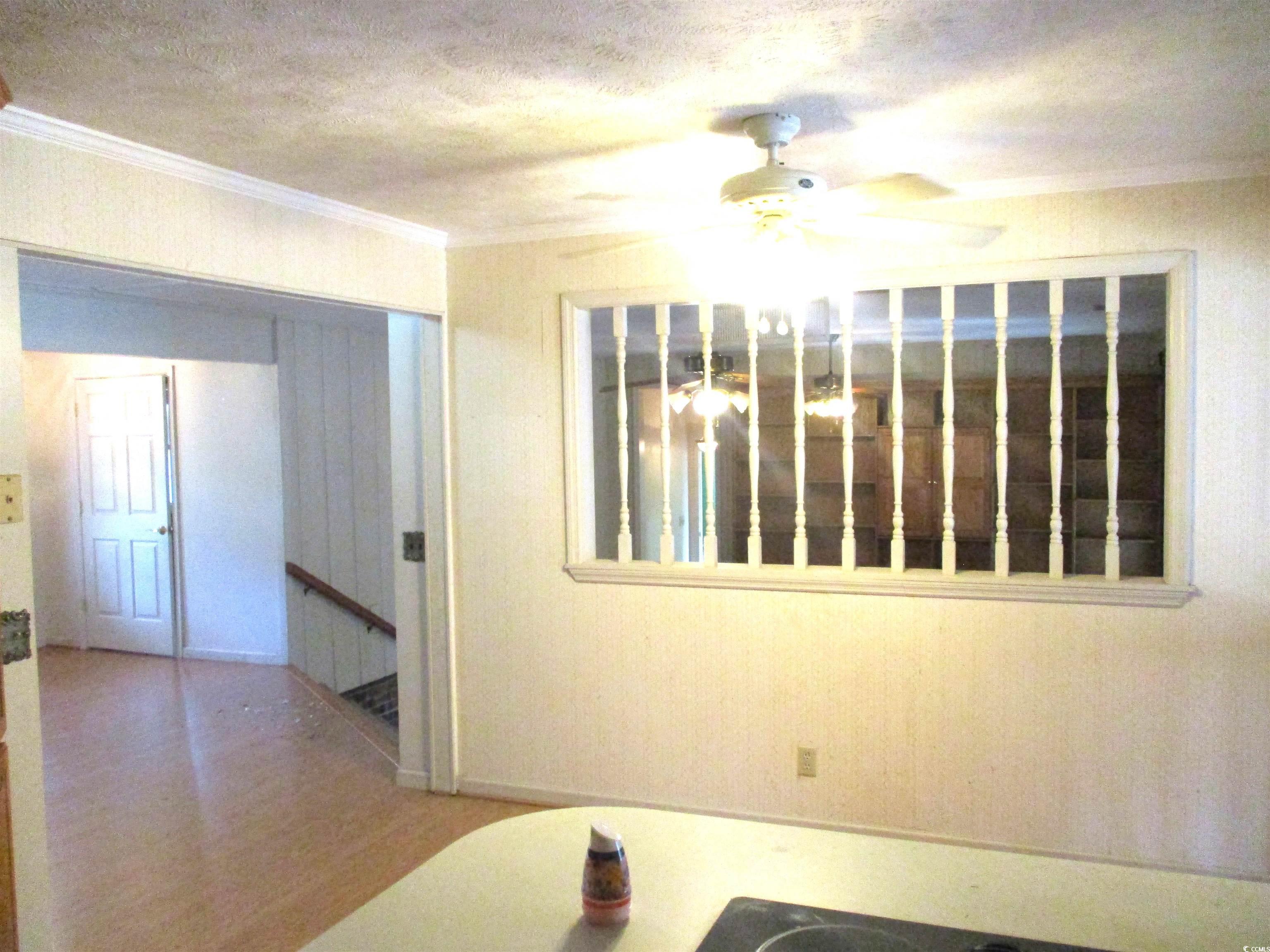 730 Highway 348 Loris, SC 29569 - Photo 16 of 36 Spare room with ornamental molding, a textured cei