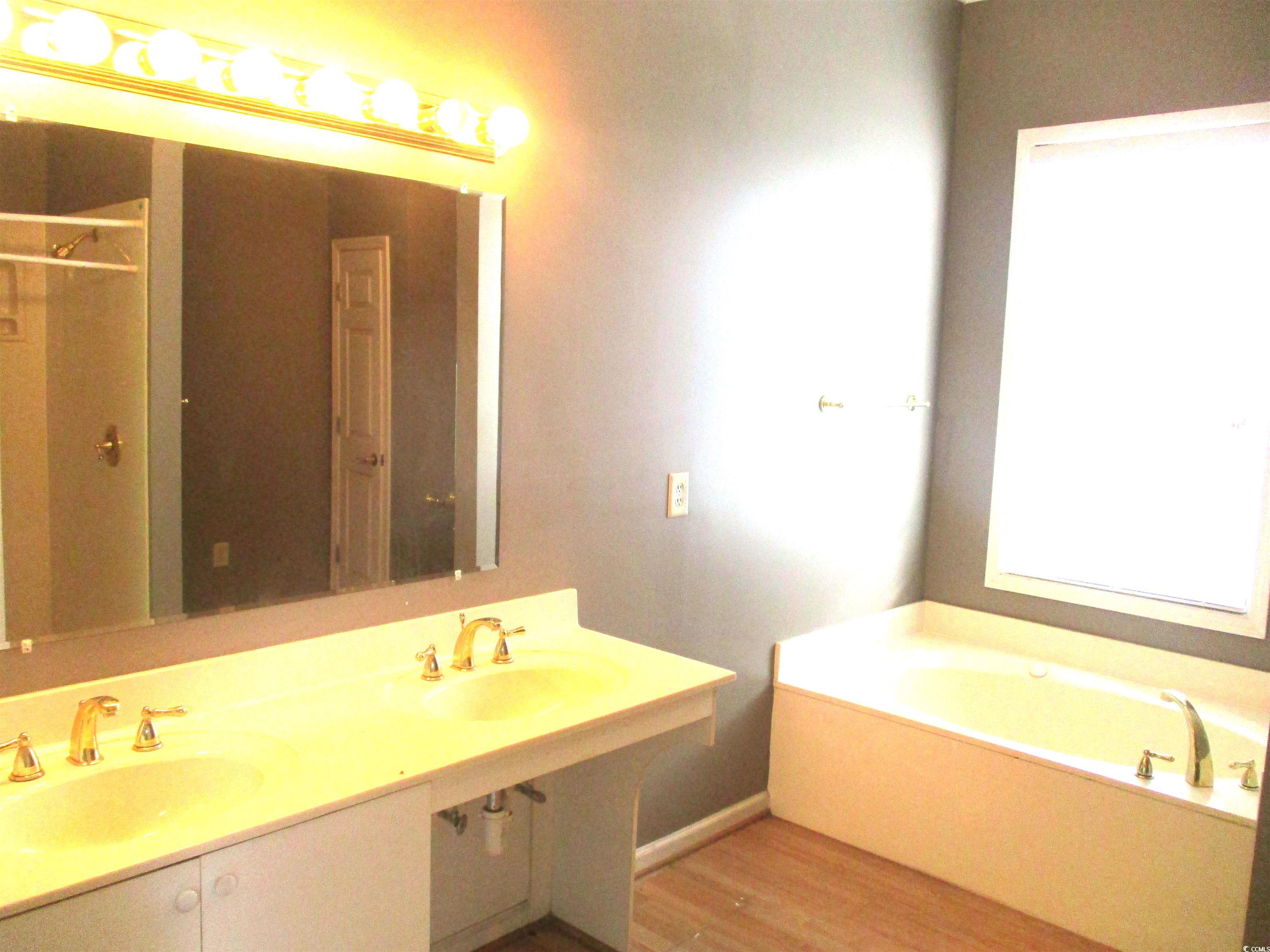 730 Highway 348 Loris, SC 29569 - Photo 19 of 36 Bathroom featuring a bathtub, hardwood / wood-styl