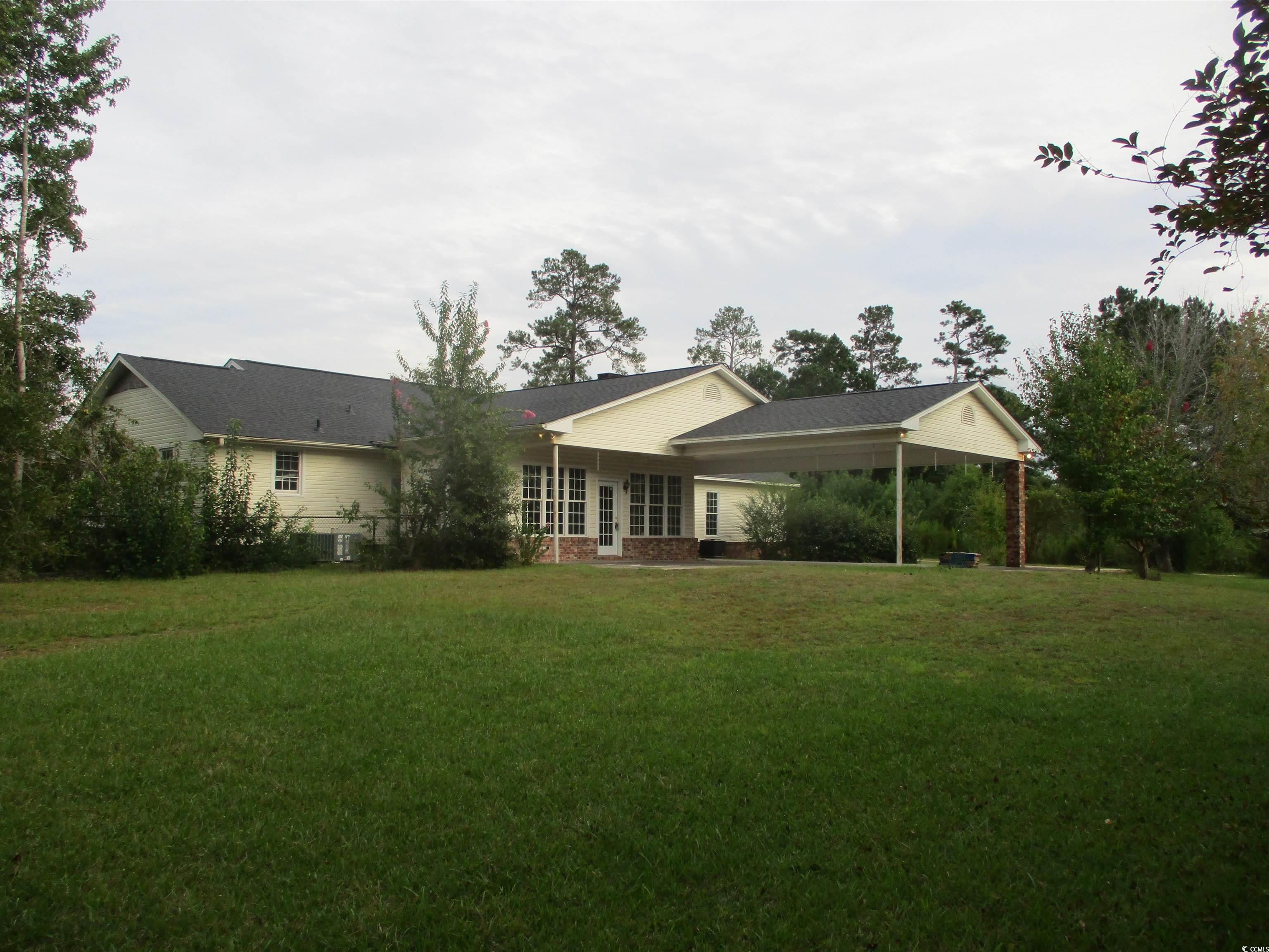 730 Highway 348 Loris, SC 29569 - Photo 9 of 36 Rear view of property with a patio area and a lawn