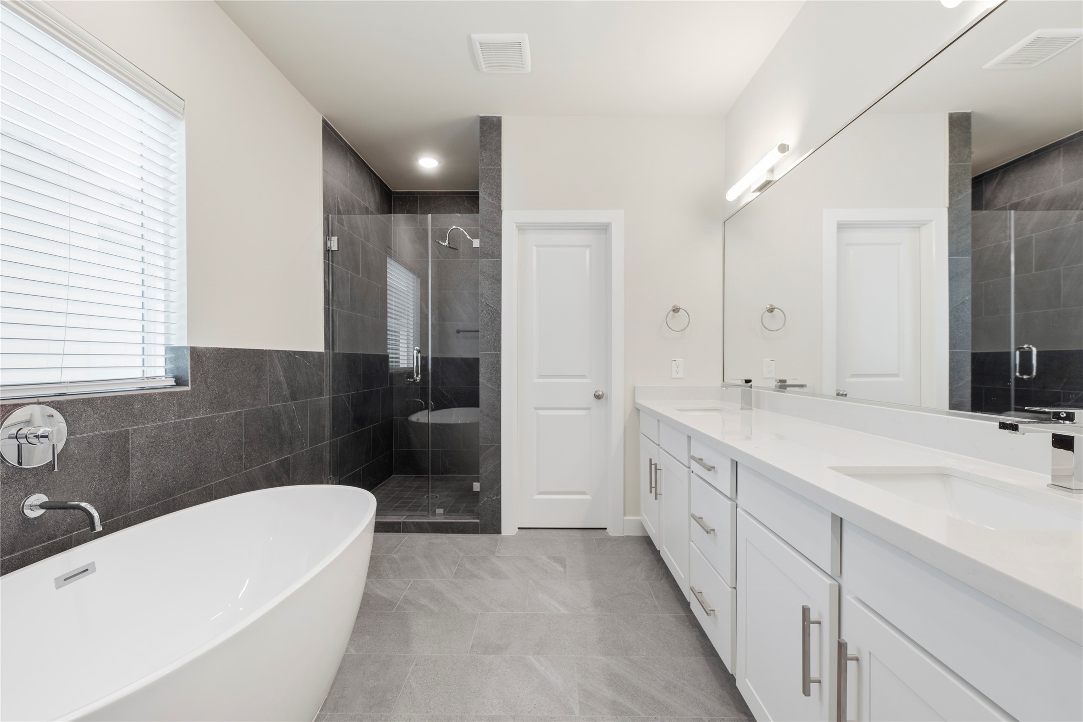 3075 Hicks Street Houston, TX 77007 - Photo 21 of 34 a bathroom with a double vanity sink a toilet a mirror and shower