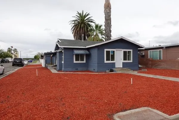 a front view of a house with yard and porch