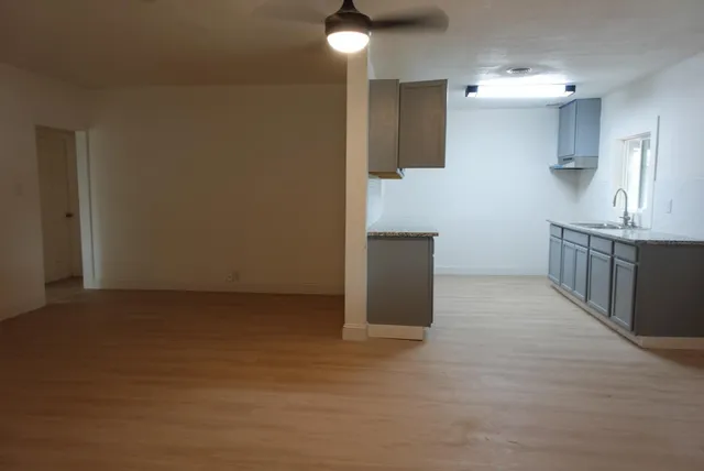 a view of kitchen with furniture and wooden floor