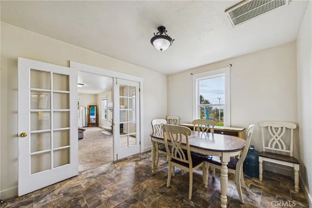 a view of a dining room with furniture and a table