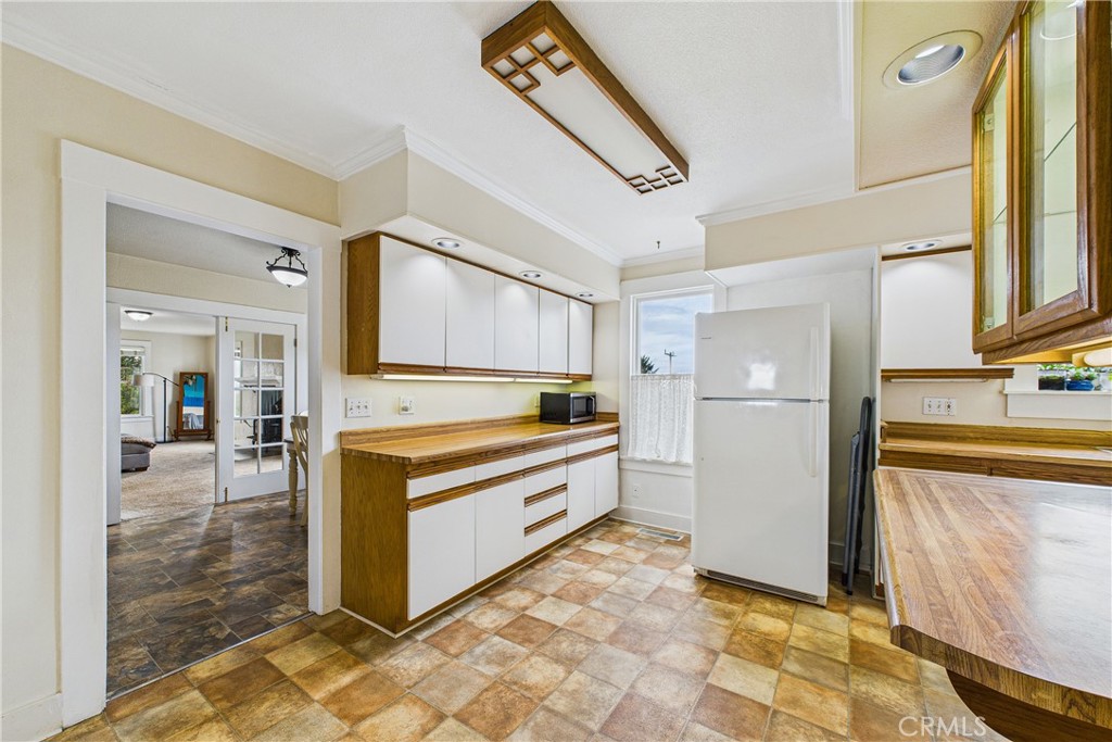 5863 Elk River Road Eureka, CA 95503 - Photo 15 of 42 a large white kitchen with stainless steel appliances granite countertop a refrigerator and a stove top oven