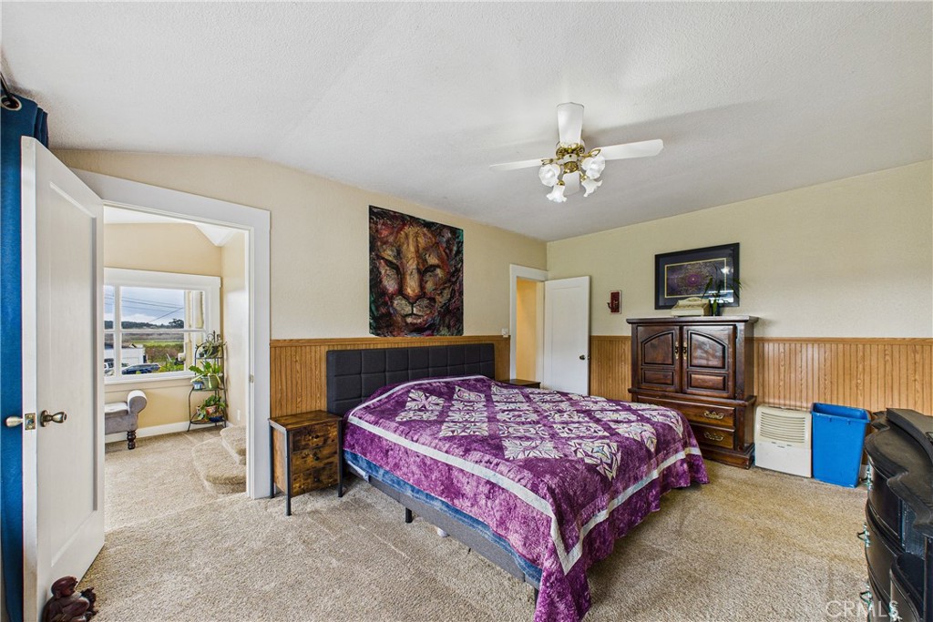 5863 Elk River Road Eureka, CA 95503 - Photo 19 of 42 a bedroom with a bed and wooden floor