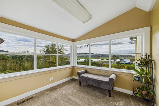 a view of a room with gym equipment and a large window