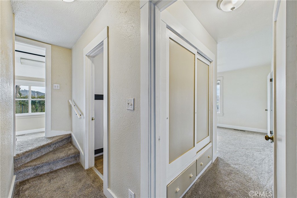 5863 Elk River Road Eureka, CA 95503 - Photo 25 of 42 a view of a hallway with a door and couch