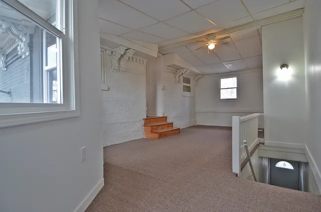 a view of a livingroom with furniture and window