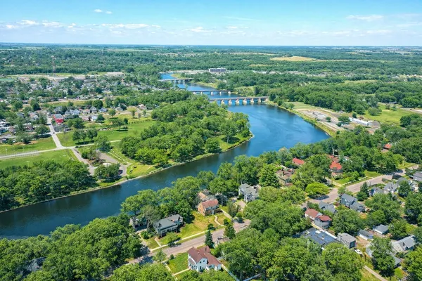 an aerial view of residential houses with outdoor space and trees