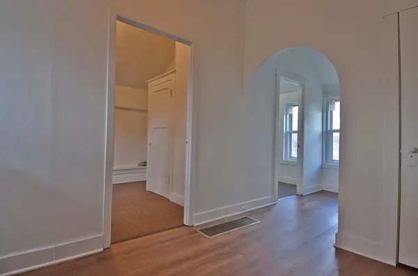 a view of a room with wooden floor