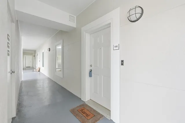 a view of a room with wooden floor