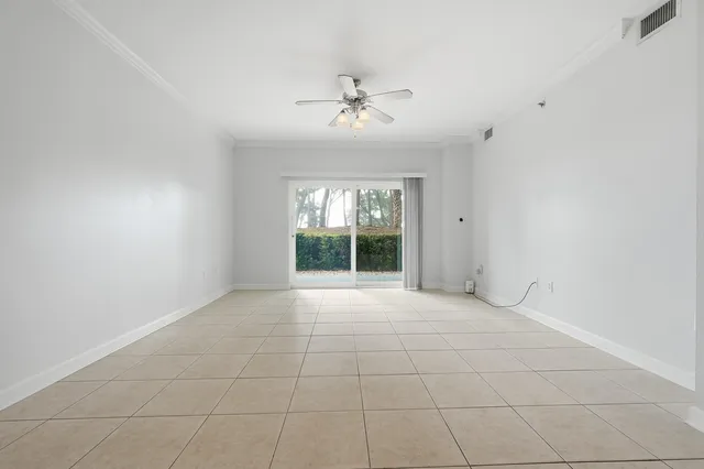 a living room with furniture a flat screen tv and kitchen view