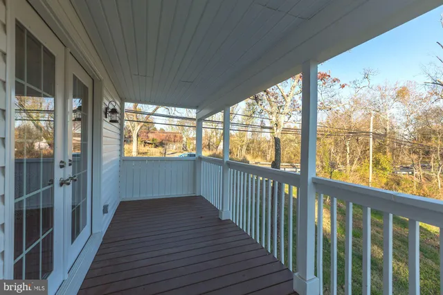 a kitchen with stainless steel appliances granite countertop a refrigerator a sink dishwasher a stove a dining table and chairs with wooden floor