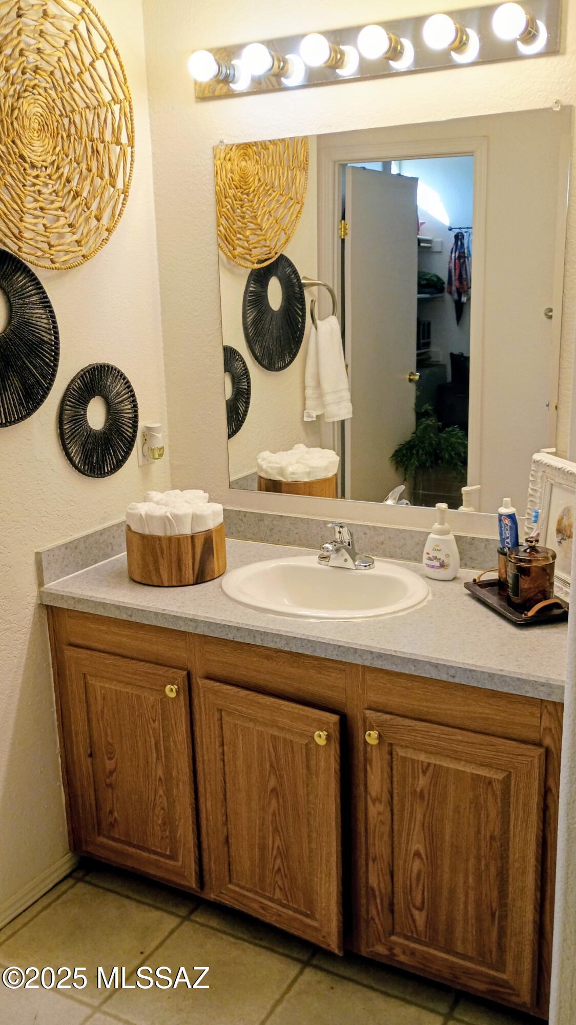 1449 West Hualpai Road Tucson, AZ 85745 - Photo 31 of 49 a bathroom with a sink and a mirror