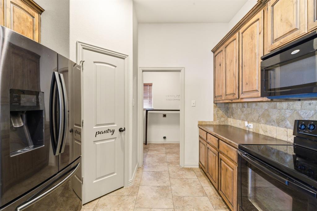 119 Cooperstown Drive Springtown, TX 76082 - Photo 11 of 33 a kitchen with stainless steel appliances a refrigerator stove and microwave