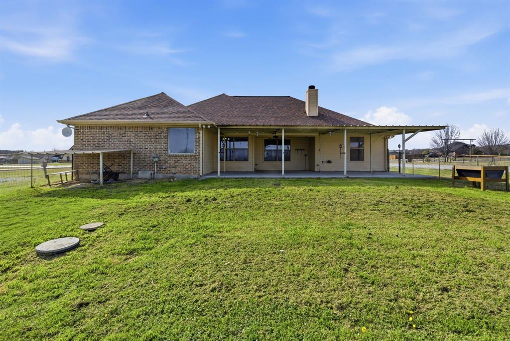 119 Cooperstown Drive Springtown, TX 76082 - Photo 26 of 33 a view of a house with a yard and sitting area