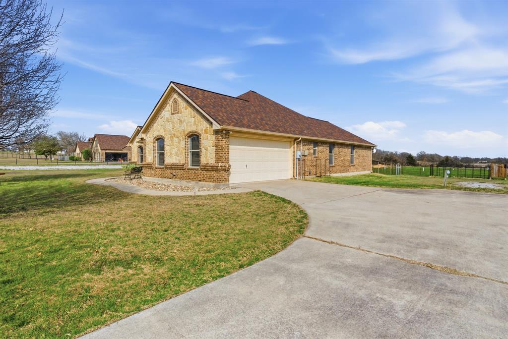 119 Cooperstown Drive Springtown, TX 76082 - Photo 31 of 33 a front view of a house with a yard