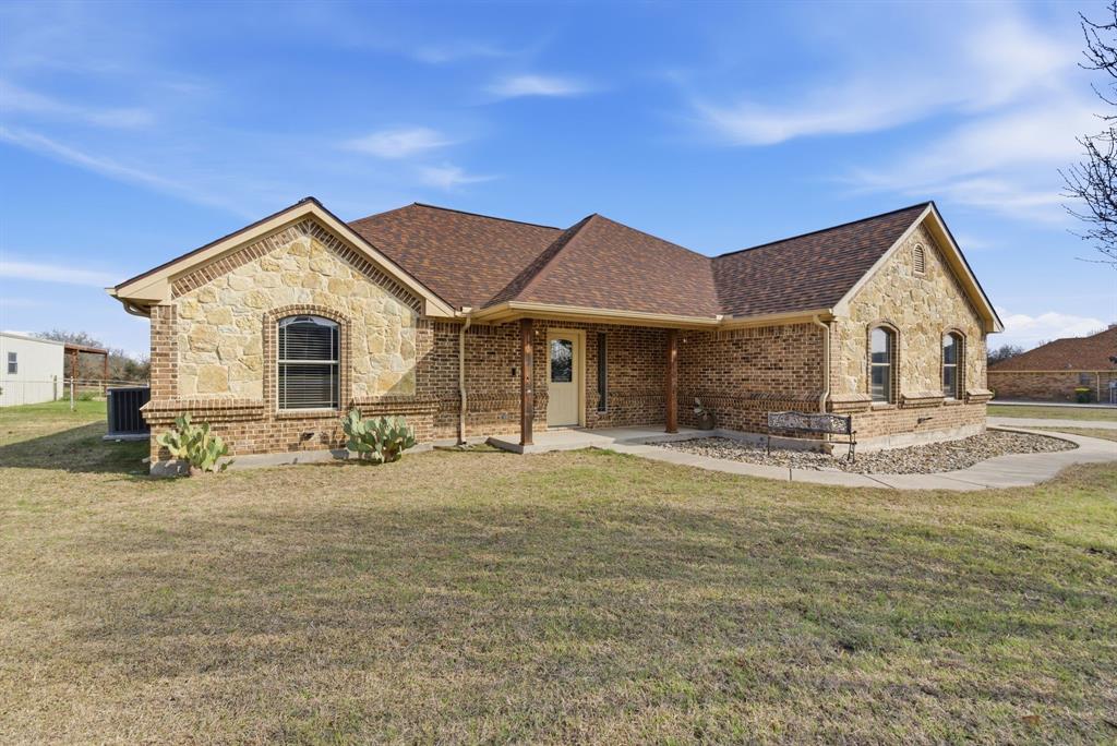 119 Cooperstown Drive Springtown, TX 76082 - Photo 33 of 33 a front view of a house with yard and porch