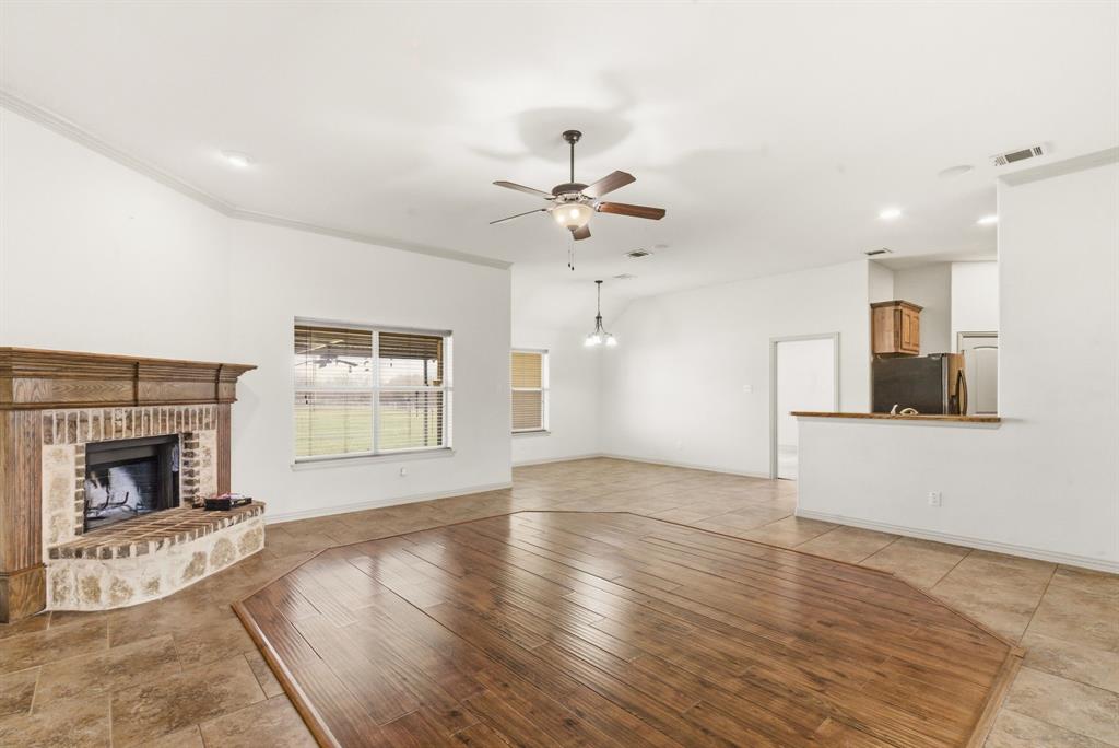 119 Cooperstown Drive Springtown, TX 76082 - Photo 5 of 33 an empty room with windows and fireplace