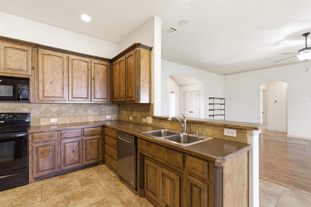 119 Cooperstown Drive Springtown, TX 76082 - Photo 6 of 33 a kitchen with stainless steel appliances granite countertop a sink stove and cabinets