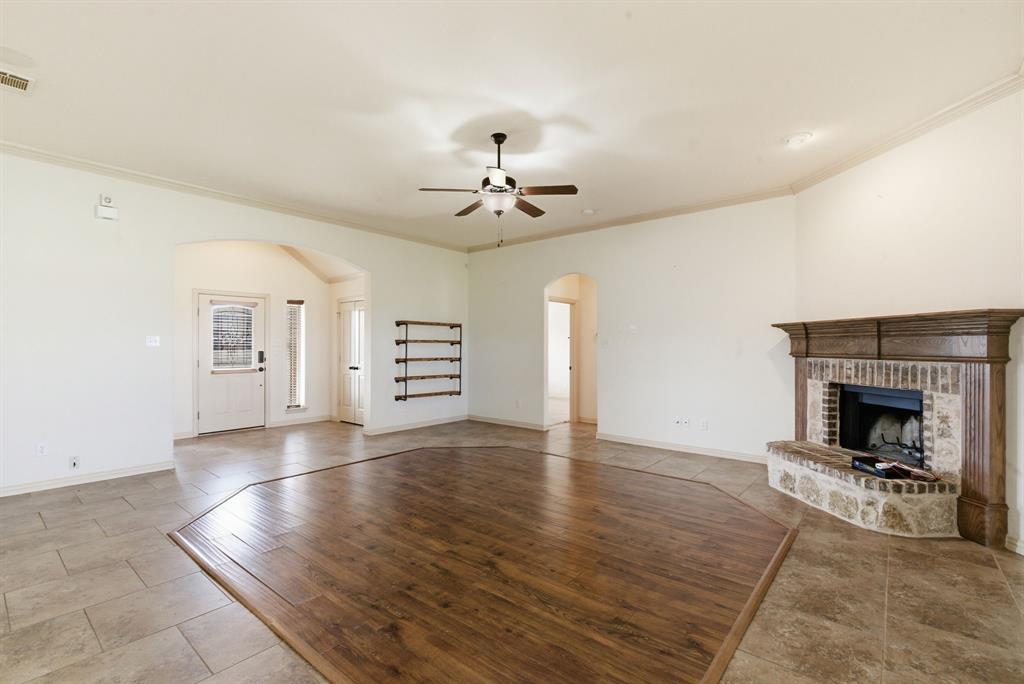 119 Cooperstown Drive Springtown, TX 76082 - Photo 9 of 33 a view of a livingroom with a fireplace a chandelier and wooden floor