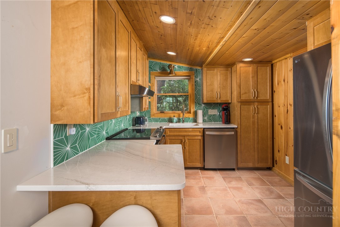 280 Chinkapin Ridge Road Seven Devils, NC 28604 - Photo 10 of 40 a kitchen with a refrigerator and a sink