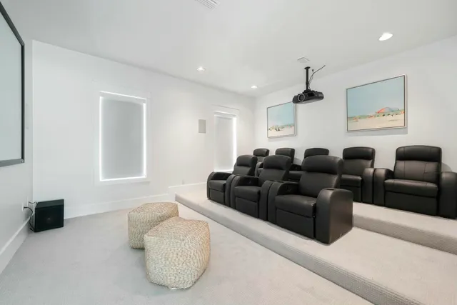 a bedroom with a large bed and a chandelier fan