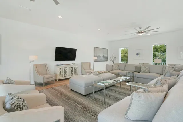 a living room with furniture and a view of kitchen