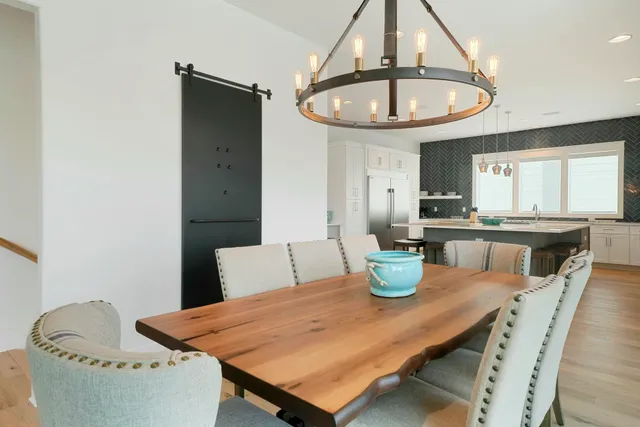 a dining table with chairs and window