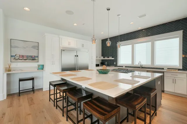 a kitchen that has a table and chairs in it