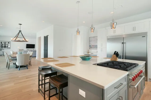 a kitchen with a dining table chairs sink and cabinets