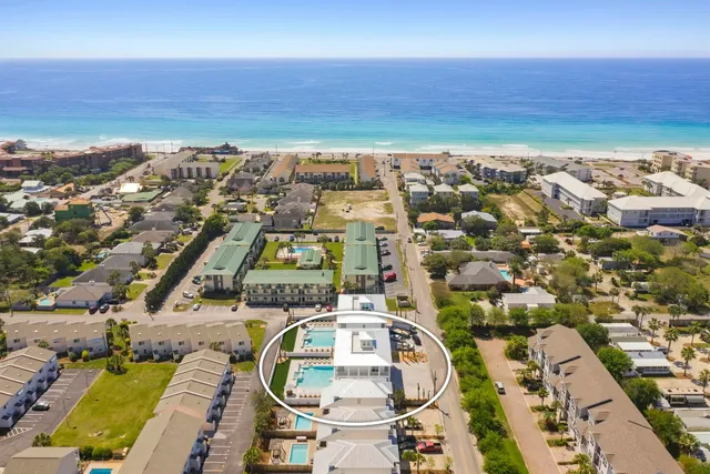 an aerial view of residential building and ocean