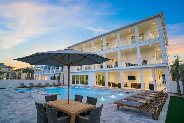 a patio with a table and chairs under an umbrella