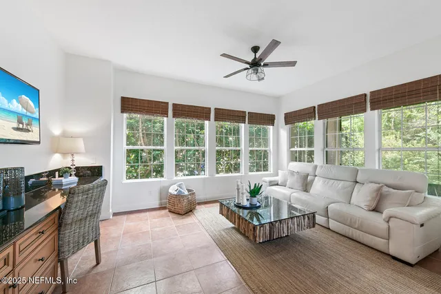 a white bath tub sitting in a bathroom next to a window