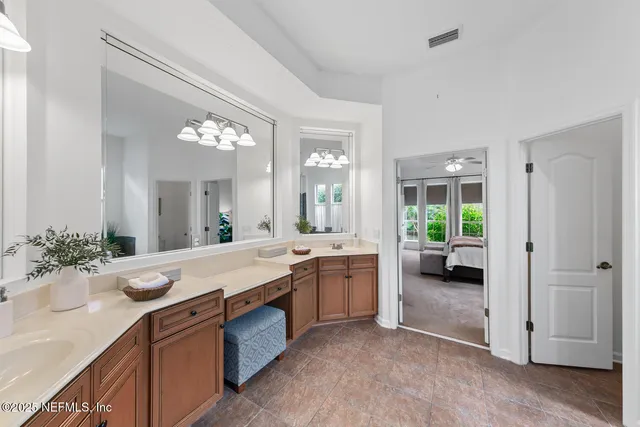 a bathroom with a sink a toilet a mirror and shower curtain
