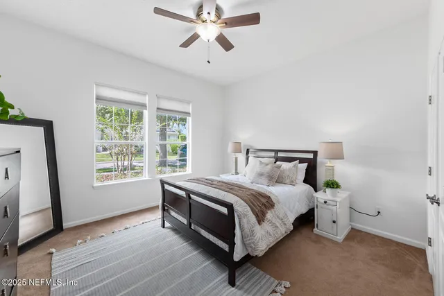 a dining room with furniture and a floor to ceiling window