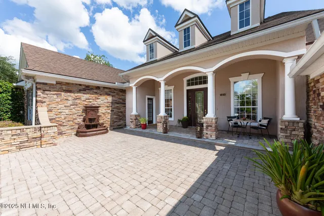 a view of a brick house with many windows