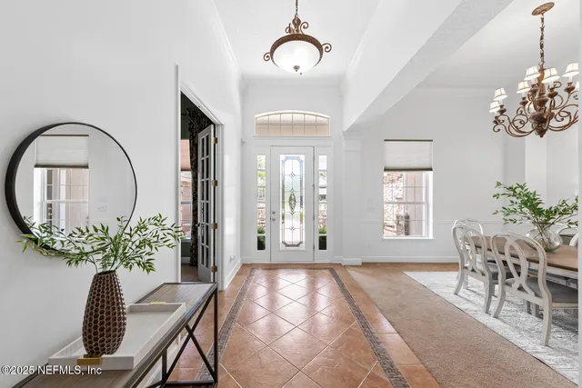 a living room with furniture a fireplace and a floor to ceiling window
