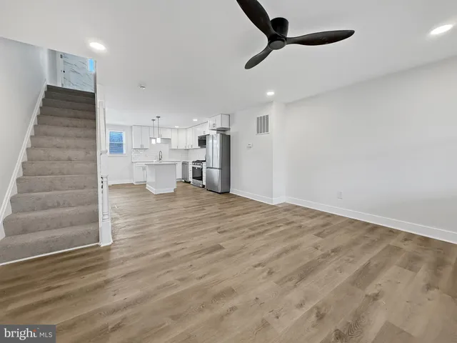 a view of a kitchen and empty room