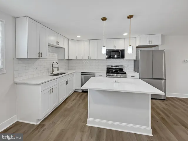 a kitchen with a sink a stove and a refrigerator