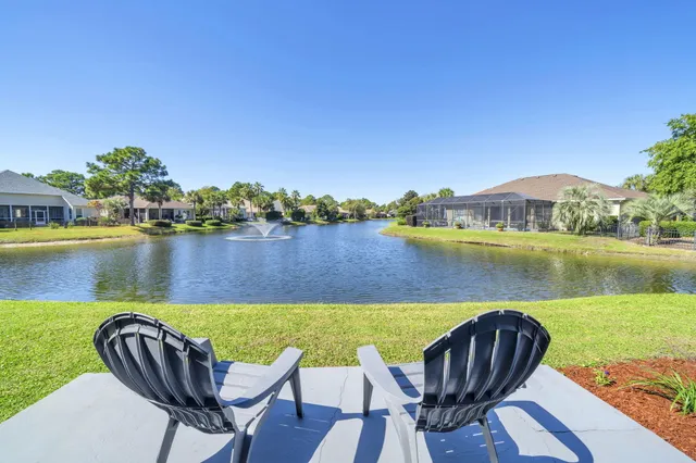 a view of a lake with couches in the patio