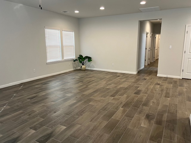 221 Arabian Colt Drive Georgetown, TX 78626 - Photo 12 of 36 an empty room with wooden floor and windows