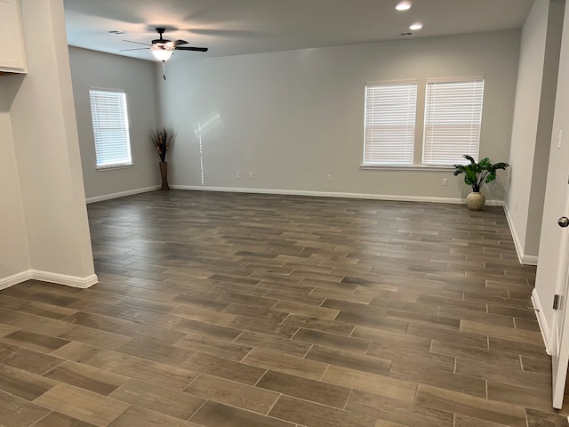 221 Arabian Colt Drive Georgetown, TX 78626 - Photo 14 of 36 an empty room with wooden floor and windows