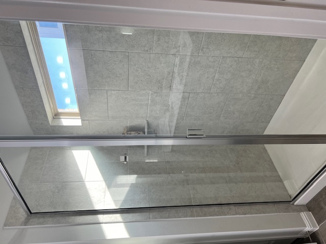 221 Arabian Colt Drive Georgetown, TX 78626 - Photo 20 of 36 a bathroom with a glass shower door