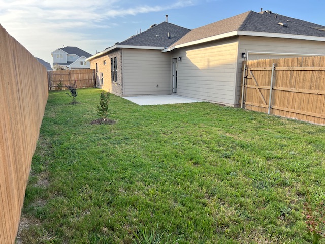 221 Arabian Colt Drive Georgetown, TX 78626 - Photo 25 of 36 a view of a house with a small yard and garage