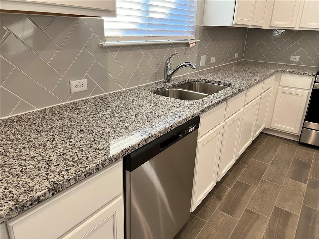221 Arabian Colt Drive Georgetown, TX 78626 - Photo 7 of 36 a kitchen with a sink and cabinets