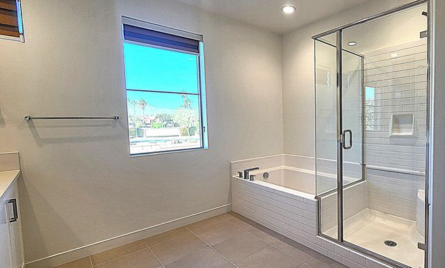 a bathroom with a bathtub and shower
