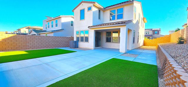 a view of a house with a yard and furniture