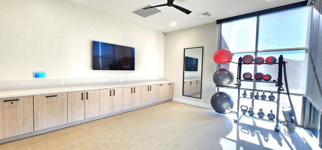 a kitchen filled with a white stove top oven and cabinets