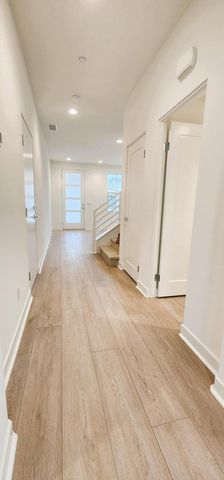 an empty room with wooden floor and white walls